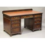 A late Victorian mahogany twin pedestal desk, the moulded top inset with a red gilt-tooled leather