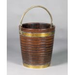 A George III style mahogany and brass bound peat bucket, the horizontally reeded body with an