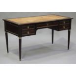 A 20th century Empire style mahogany desk with gilt metal mounts, the top inset with gilt-tooled tan