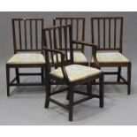 A set of four George III provincial fruitwood rail back dining chairs, comprising a carver and three