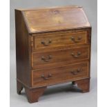An Edwardian mahogany bureau with inlaid decoration, the fall front above three long drawers, on