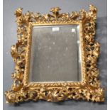 A late 19th century Florentine giltwood wall mirror, the frame finely carved with overall