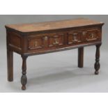 An early 18th century oak dresser base, fitted with two frieze drawers, raised on turned baluster