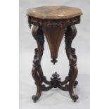 An early Victorian rosewood octagonal work table, raised on carved scroll legs united by stretchers,