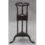 A 19th century mahogany washstand, the circular top above two drawers, on tripod cabriole legs,