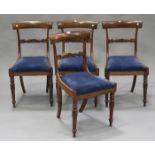 A set of four William IV rosewood dining chairs with carved centre rails and drop-in seats, on