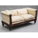 A William IV mahogany two seat settee with carved decoration, the seat, back and arms upholstered in