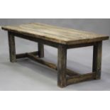 A 19th century and later reclaimed pine rectangular farmhouse table, the thick plank top on block