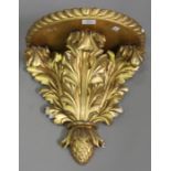 A Victorian carved giltwood wall bracket, the gadrooned shelf above an acanthus leaf support and