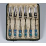 A set of six Liberty & Co 'Cymric' silver and enamelled pastry forks, designed by Archibald Knox,