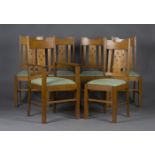 A set of six early/mid-20th century Arts and Crafts style oak dining chairs, comprising a carver and