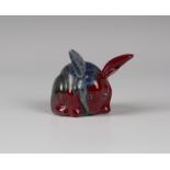 A Bernard Moore red flambé glazed model of a rabbit, early 20th century, with blue and green streaky