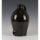 A large St Ives studio pottery flagon, the gently ribbed body covered in a dark brown glaze,