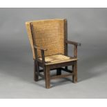 A mid-20th century oak framed Orkney child's armchair, the curved woven straw back with upright