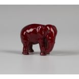 A Bernard Moore red flambé glazed model of a standing elephant, early 20th century, with applied