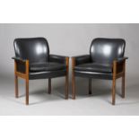 A pair of mid-20th century rosewood framed and black leather armchairs, in the manner of Finn