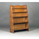 An Edwardian Arts and Crafts oak five-tier graduated waterfall bookcase, possibly Wylie &