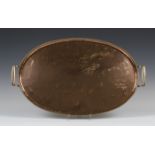 An Arts and Crafts copper oval tray by Hugh Wallis, the overall hammered body with an upturned rim