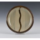 A St Ives studio pottery circular dish, attributed to Bernard Leach, painted with a central