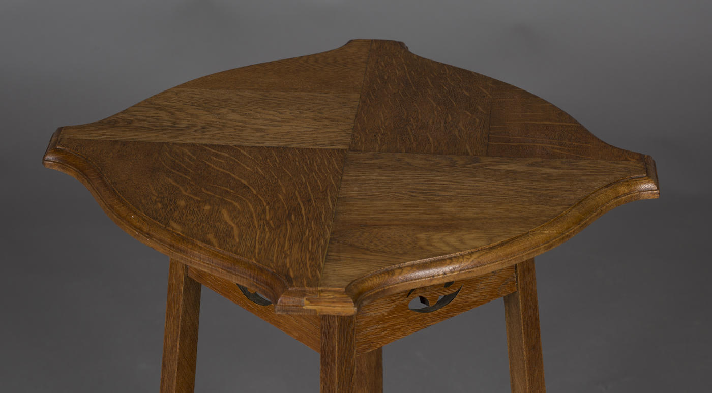 An Edwardian Arts and Crafts oak two-tier occasional table, probably by Liberty & Co, the - Image 2 of 2