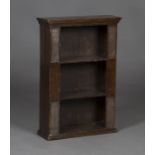 An early 20th century Arts and Crafts style stained pine open bookshelf, the sides with four applied