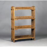 An early 20th century Arts and Crafts oak four-tier open bookcase of pegged construction, probably