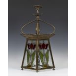 A late 19th/early 20th century Arts and Crafts Glasgow School brass framed hanging hall lantern, the