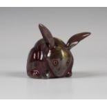 A Bernard Moore red flambé glazed model of a rabbit, early 20th century, with yellow mottled