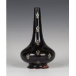 A Bernard Moore flambé glazed bottle vase, early 20th century, the aubergine body with speckled