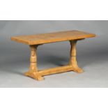 A Robert 'Mouseman' Thompson oak rectangular coffee table, the heavily adzed top raised on a pair of