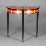 A modern demi-lune side table, inlaid in red, yellow, black and green stained woods, raised on