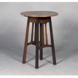 An Edwardian Arts and Crafts style mahogany circular occasional table, the top with a crossbanded