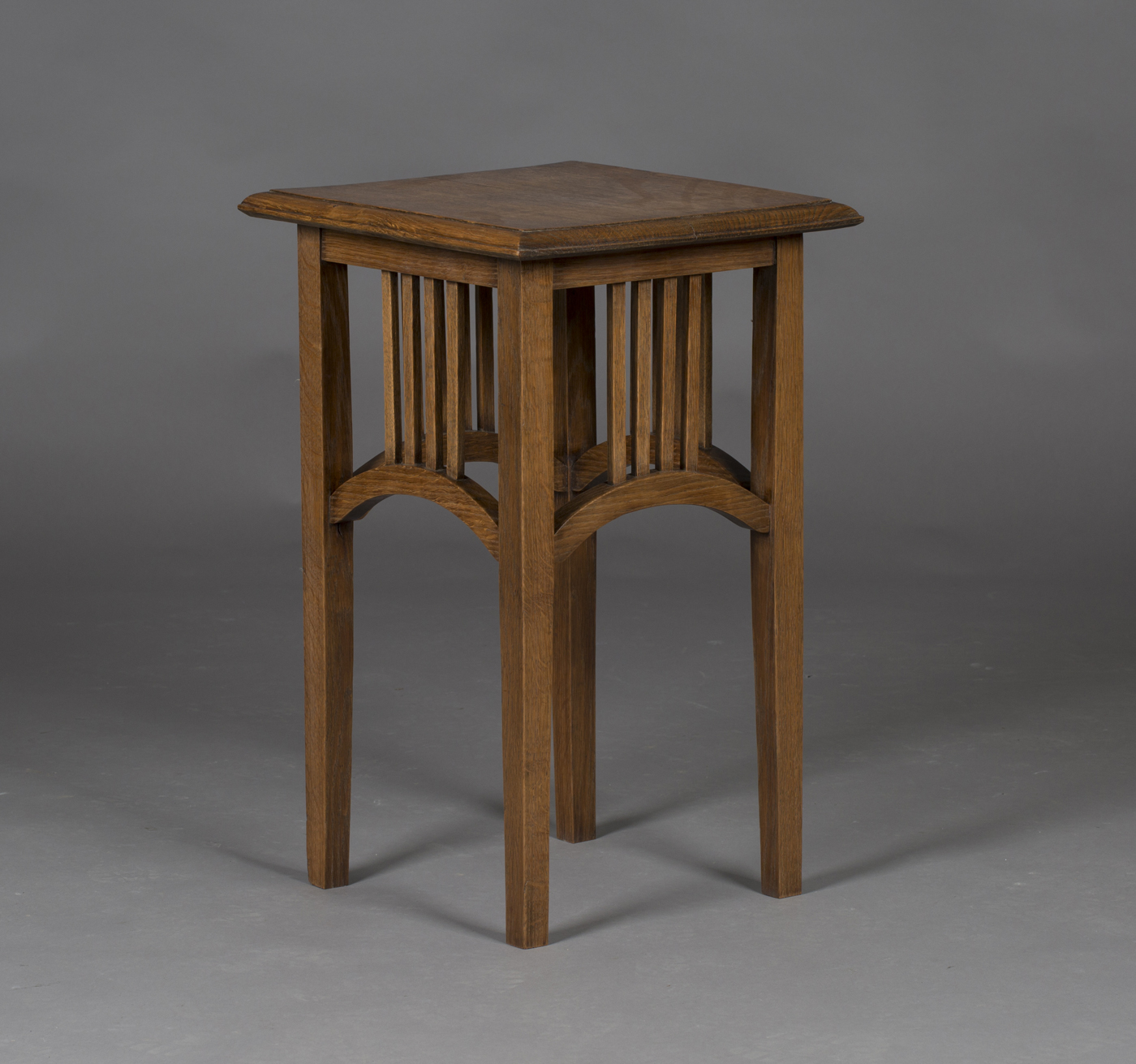 An Edwardian Arts and Crafts oak occasional table, in the manner of Liberty & Co, the square top