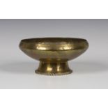 An Arts and Crafts brass circular bowl by Hugh Wallis with an overall hammered body, the spreading