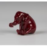 A Bernard Moore red flambé glazed model of a seated elephant, early 20th century, with applied glass