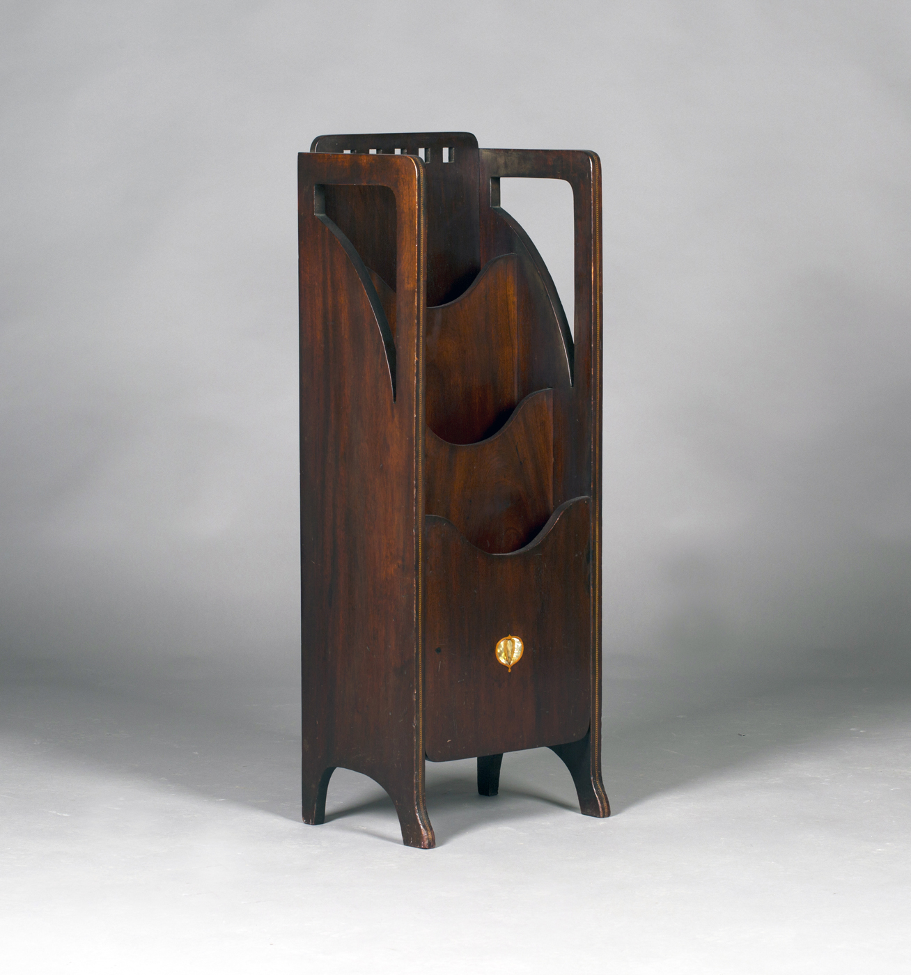 An Edwardian Arts and Crafts Glasgow School mahogany magazine rack, probably by Wylie & Lochhead,