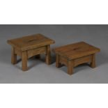A graduated pair of early 20th century Arts and Crafts style oak rectangular hearth stools, each