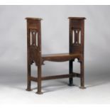 An Edwardian Arts and Crafts oak window seat, the solid seat flanked by pierced sides, the block