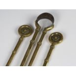 A set of three late Victorian Aesthetic period brass fire tools, the shovel and poker handle with