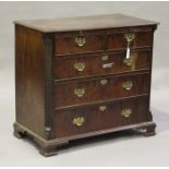 A George III mahogany chest of two short and three long graduated drawers, fitted with a brushing