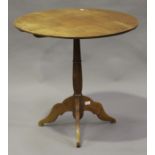 An early 20th century French walnut tip-top circular wine table, on a turned column and tripod