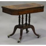 A Regency rosewood fold-over card table with overall crossbanded borders, raised on turned