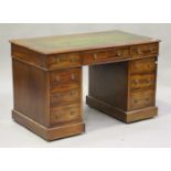 A Victorian mahogany twin pedestal desk, the moulded top inset with a green leather writing surface,