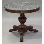 A 19th century French mahogany circular centre table, the grey marble top raised on a turned and