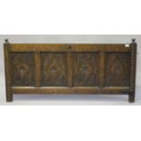 A 17th century oak panelled coffer front, the four panels carved with lozenge motifs, height 76cm,