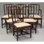 A set of six late George III Sheraton style mahogany pierced rail back dining chairs with