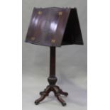 A late Victorian stained walnut double-side lectern, raised on a fluted column and four carved legs,