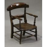 A late Victorian walnut child's armchair with a bar back and solid seat, on turned tapering legs,