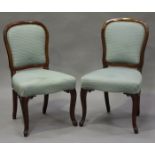 A set of ten Victorian mahogany showframe balloon back dining chairs with upholstered seats and