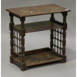 A 20th century Arts and Crafts style oak reading table, in the manner of Liberty & Co, raised on